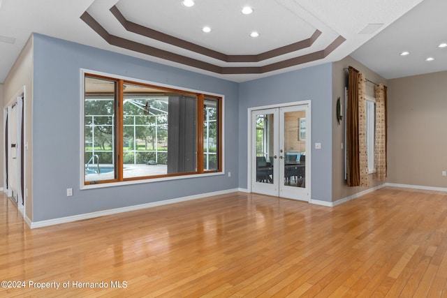 unfurnished room with light wood-type flooring and french doors