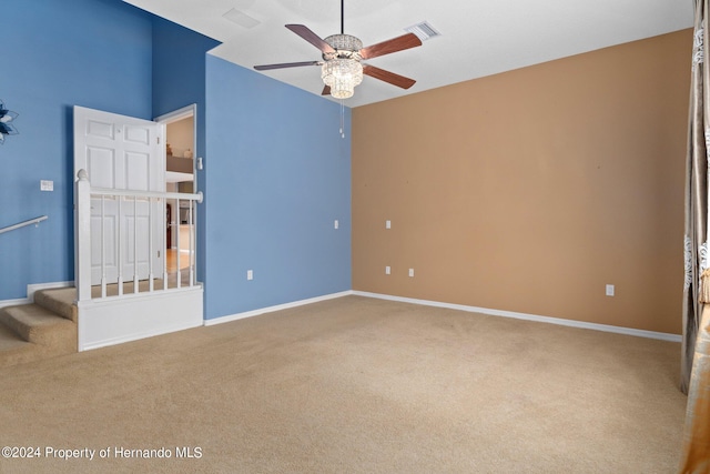 carpeted spare room with ceiling fan