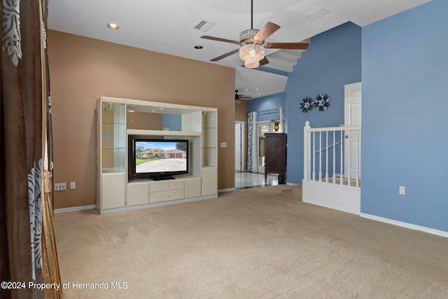 unfurnished living room featuring a healthy amount of sunlight, high vaulted ceiling, light colored carpet, and ceiling fan