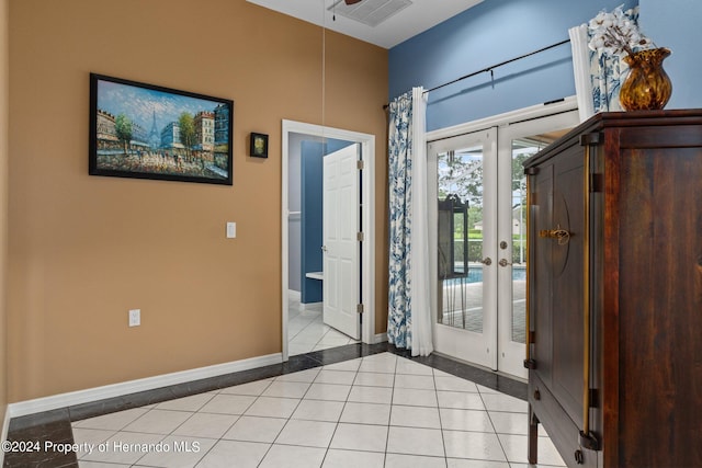 tiled entryway featuring french doors