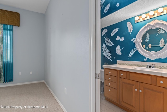 bathroom featuring vanity, tile patterned floors, and a textured ceiling