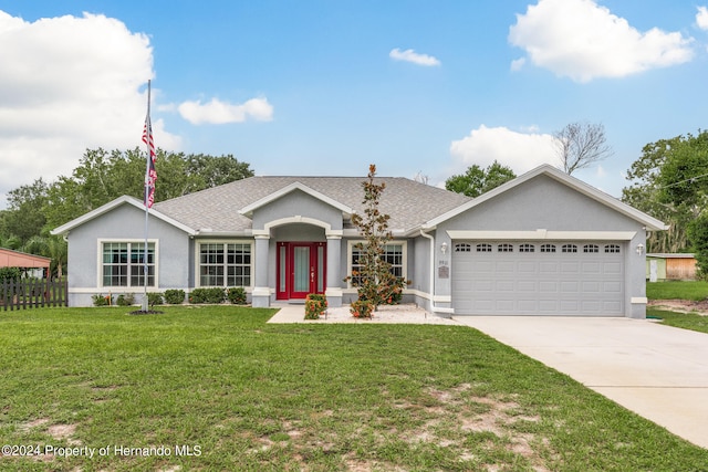 ranch-style house featuring a garage and a front yard