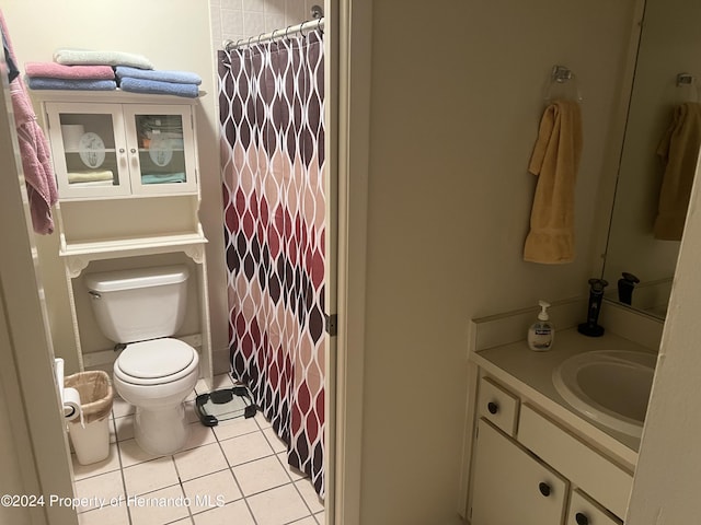 bathroom featuring toilet, vanity, a shower with shower curtain, and tile patterned flooring