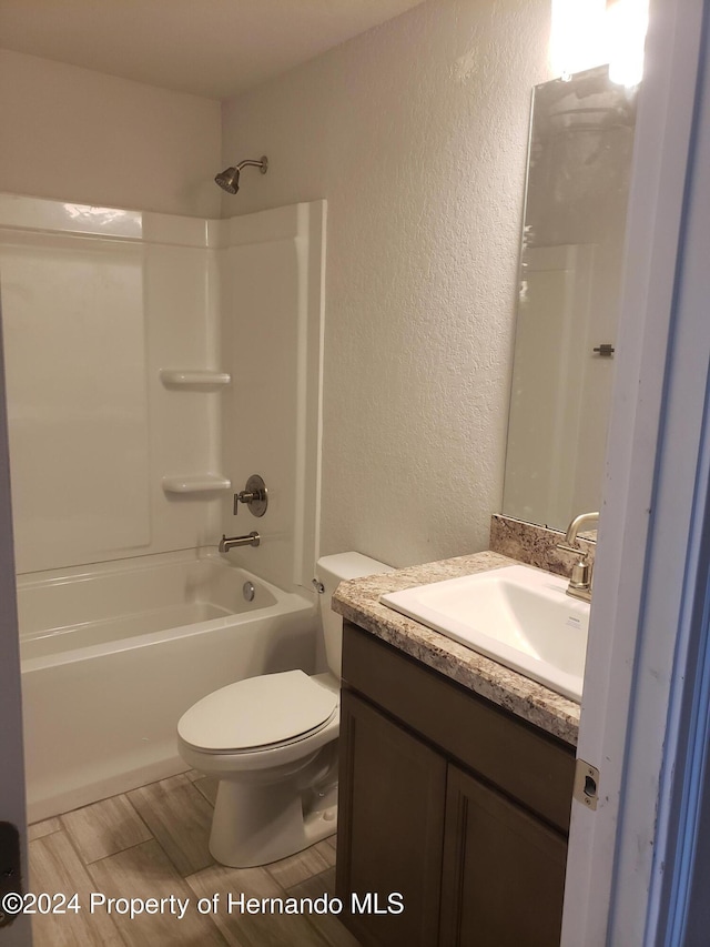 full bathroom featuring toilet, bathtub / shower combination, and vanity