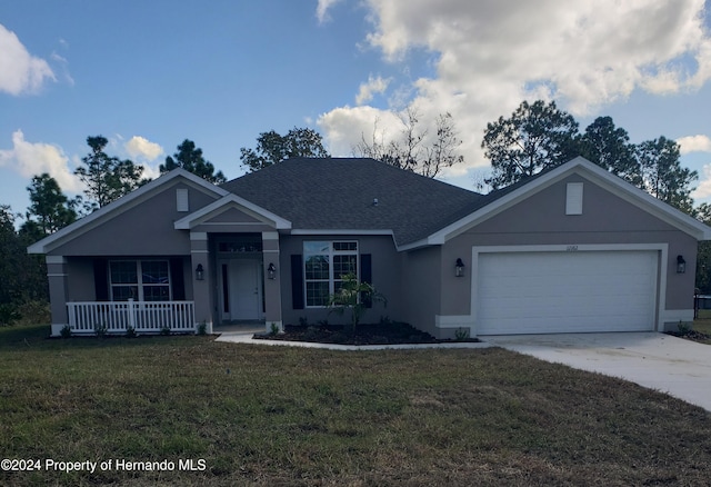 view of front of house featuring a garage, a front lawn, and a porch