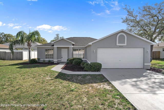 single story home with a garage and a front yard