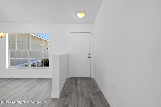 interior space with hardwood / wood-style floors and a textured ceiling