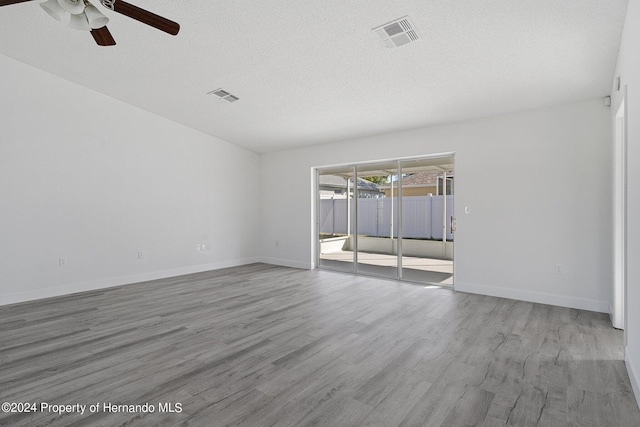 spare room featuring hardwood / wood-style floors, ceiling fan, and a textured ceiling