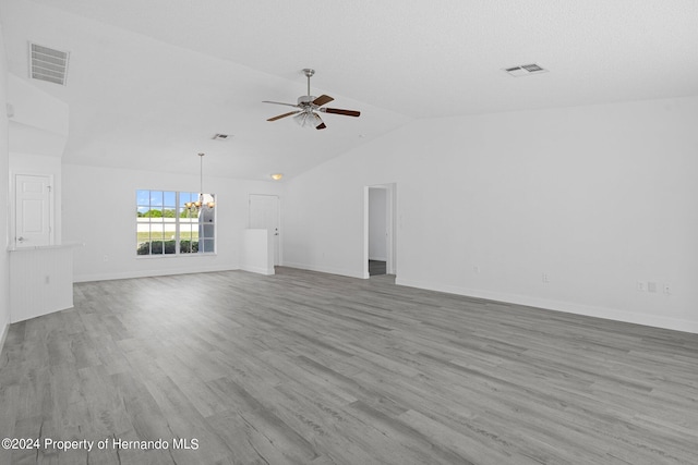 unfurnished living room featuring ceiling fan with notable chandelier, light hardwood / wood-style flooring, and lofted ceiling