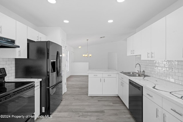 kitchen featuring white cabinetry, light wood-type flooring, black appliances, and tasteful backsplash