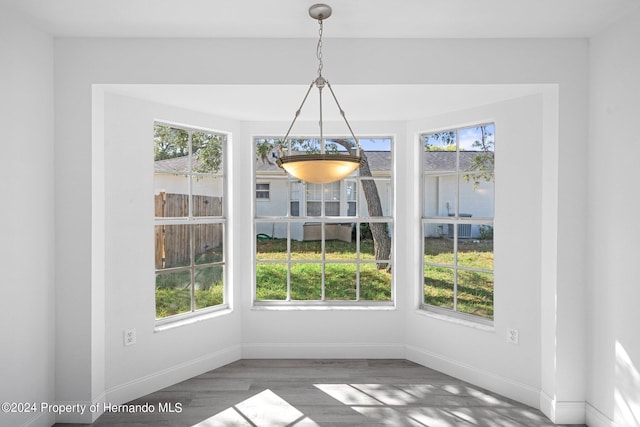 unfurnished dining area with dark hardwood / wood-style floors