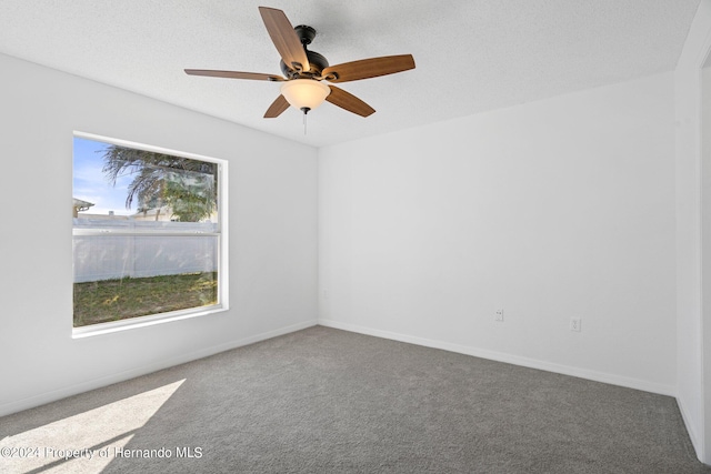 spare room featuring carpet, a textured ceiling, and ceiling fan