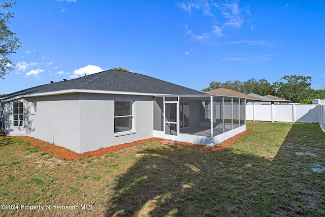 back of house featuring a sunroom and a yard