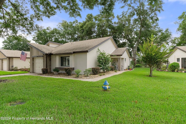 ranch-style home with a garage and a front yard