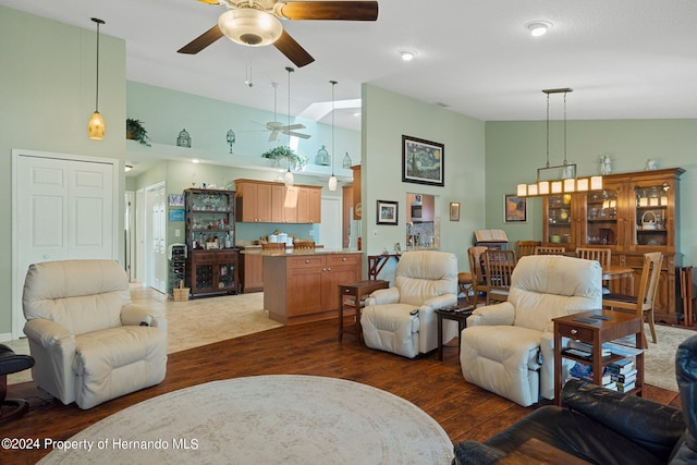 living room with dark hardwood / wood-style flooring, high vaulted ceiling, and ceiling fan