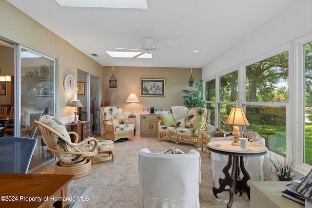 sunroom featuring ceiling fan and a skylight