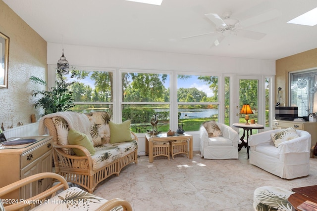 sunroom featuring a skylight and ceiling fan