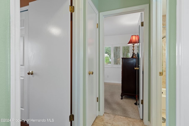 hall with light tile patterned floors