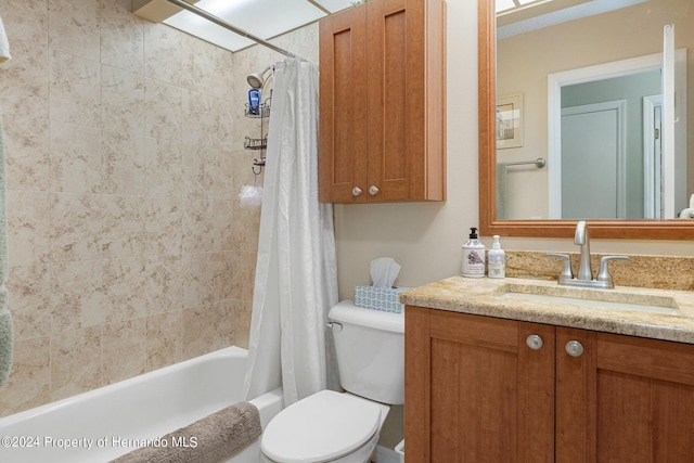 full bathroom featuring toilet, shower / bath combo, and vanity