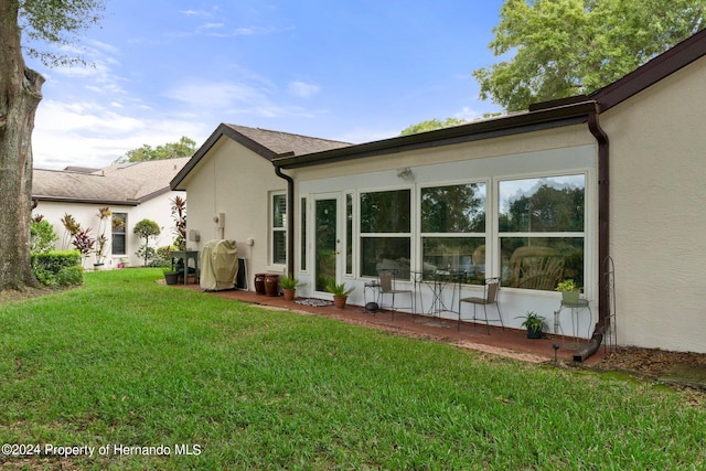 back of property featuring a yard