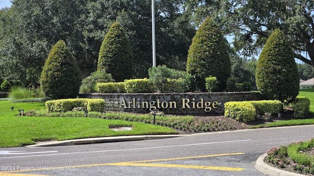 community sign featuring a lawn