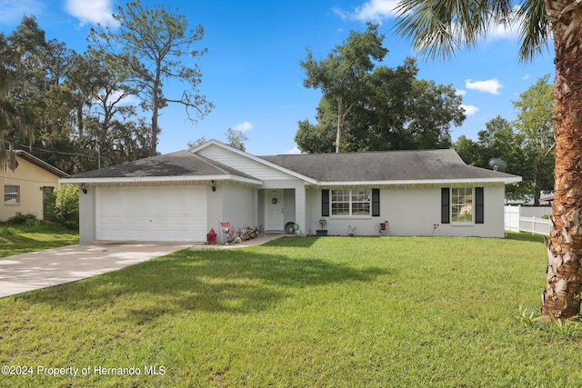 ranch-style home with a garage and a front yard