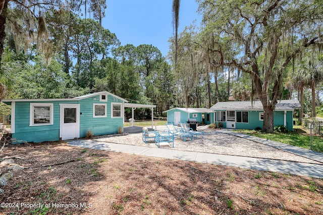 back of property with a carport