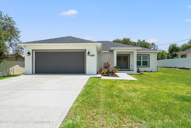 view of front of property with a garage and a front lawn