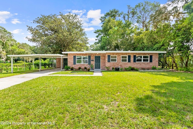 ranch-style house with a front lawn and a carport