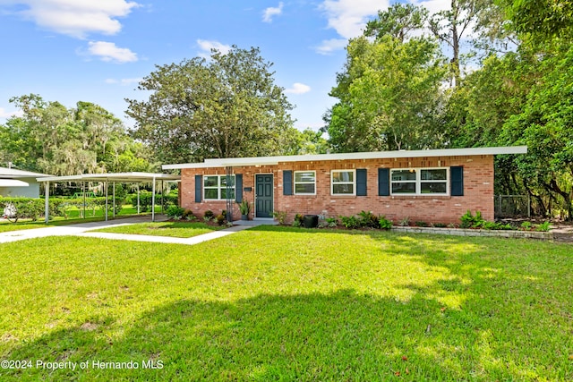 single story home featuring a carport and a front lawn