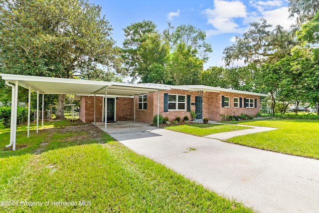 ranch-style house featuring a front yard and a carport