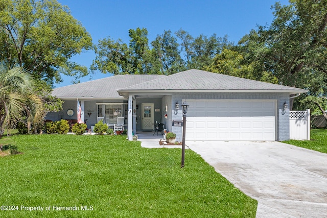 ranch-style home with a porch, a garage, and a front yard