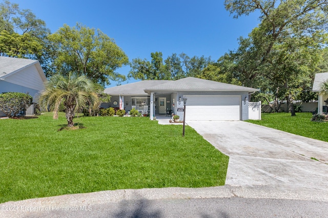 ranch-style home featuring a front lawn and a garage