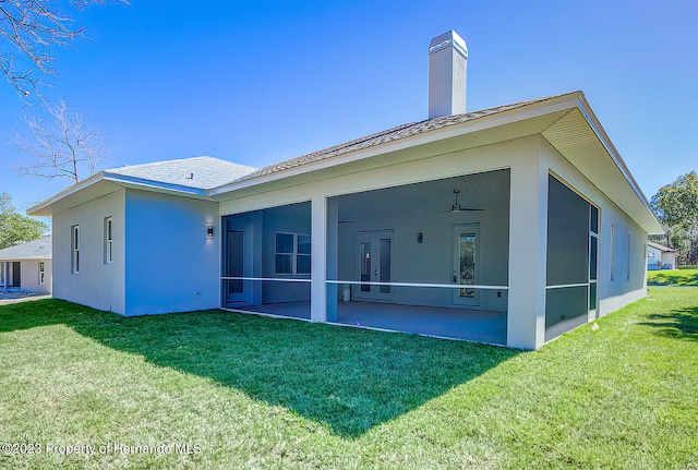 back of house with a patio, a sunroom, and a yard