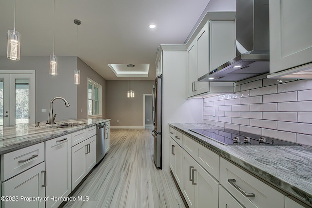 kitchen with white cabinetry, sink, wall chimney exhaust hood, and stainless steel appliances