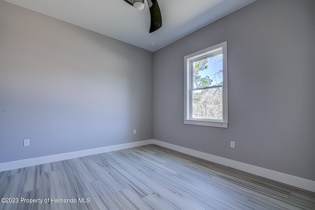 spare room featuring light hardwood / wood-style floors and ceiling fan