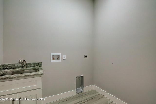 laundry room with light wood-type flooring, hookup for a washing machine, cabinets, sink, and electric dryer hookup