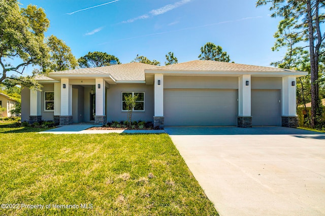 view of front of house with a garage and a front lawn