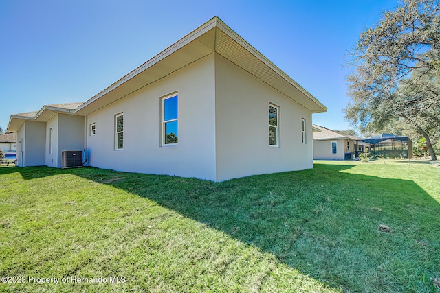 view of side of home featuring central air condition unit, a lawn, and a gazebo