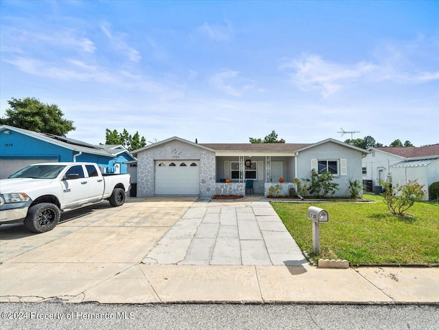 single story home featuring a porch, a front lawn, and a garage