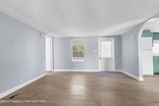 spare room with a textured ceiling and hardwood / wood-style flooring