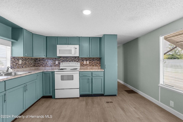 kitchen featuring light hardwood / wood-style flooring, tasteful backsplash, sink, and white appliances