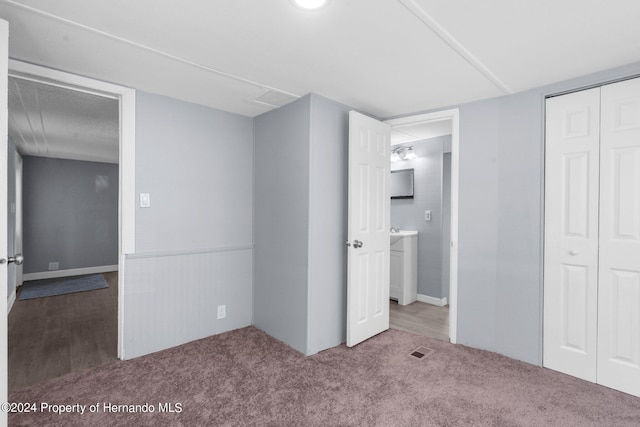 unfurnished bedroom featuring a closet and carpet flooring