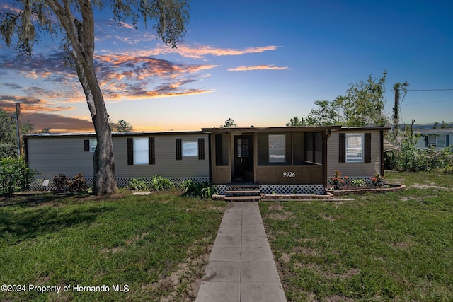 single story home with a lawn