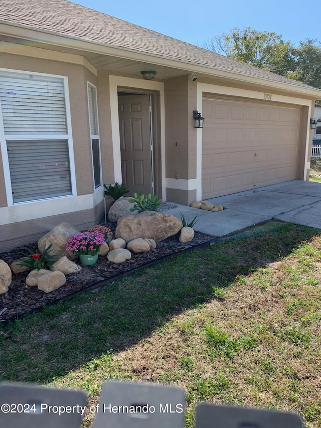 view of exterior entry with a garage