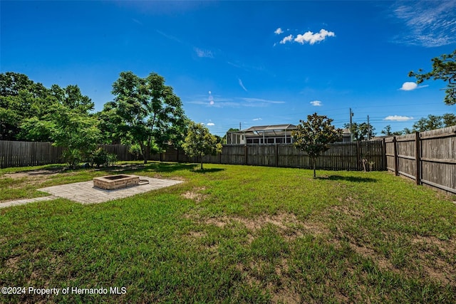 view of yard with an outdoor fire pit and a patio area