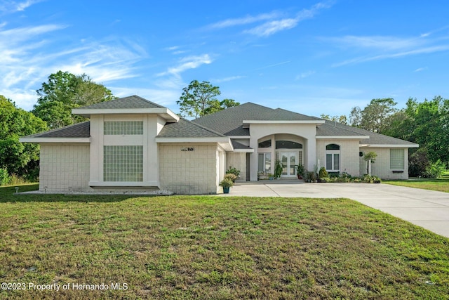 view of front of house with french doors and a front yard