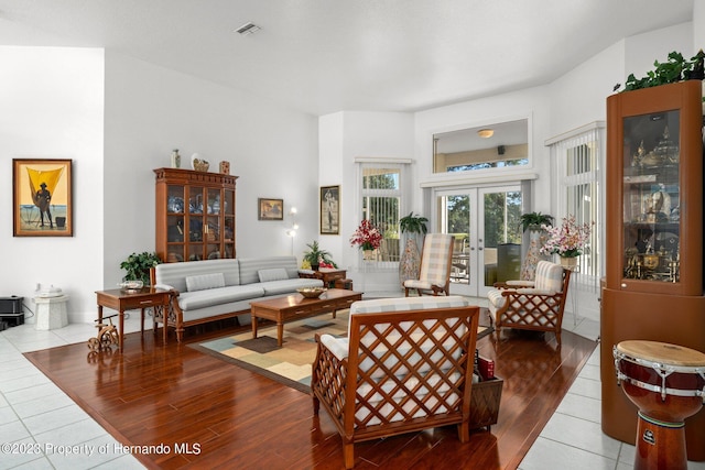 living room with french doors and hardwood / wood-style flooring