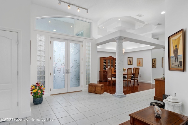 foyer featuring decorative columns, french doors, and light tile patterned floors