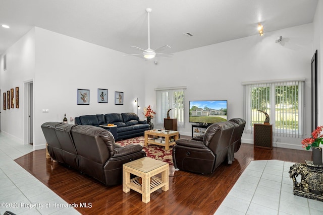 living room with high vaulted ceiling, hardwood / wood-style floors, and ceiling fan